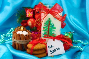 Cookies for Santa: Conceptual image of ginger cookies, milk and christmas decoration on blue background