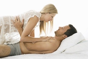 Young couple being affectionate in bed.