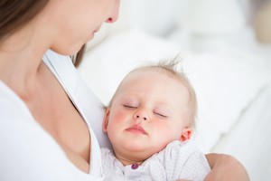 baby sleeping in arms
