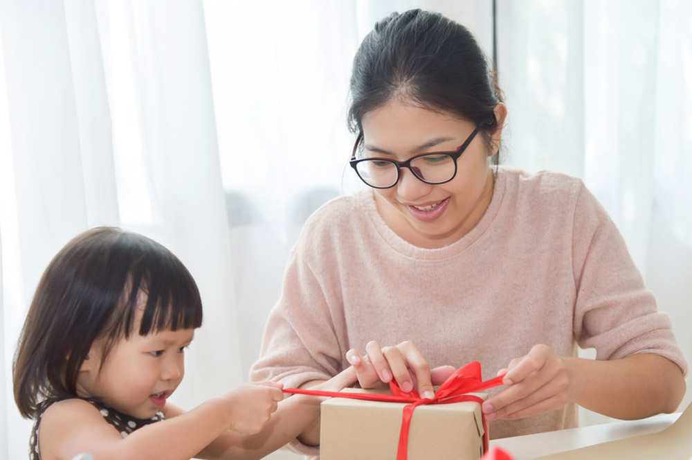 How to start an online store and work at home. Mother and toddler wrapping parcels